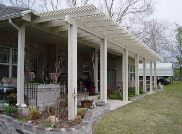 Lattice pergola beside a brick home