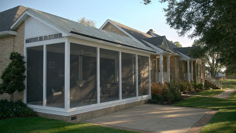 New white aluminum screen room on a brick home