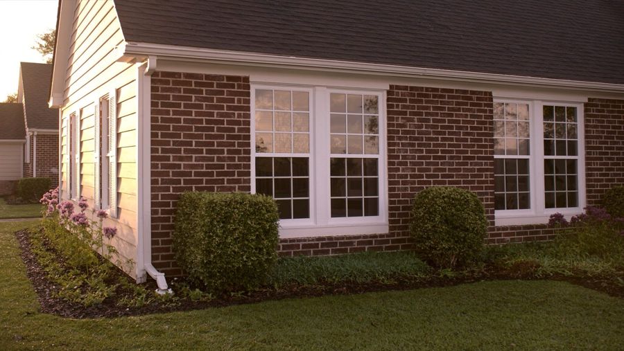 New white replacement windows on a brick home