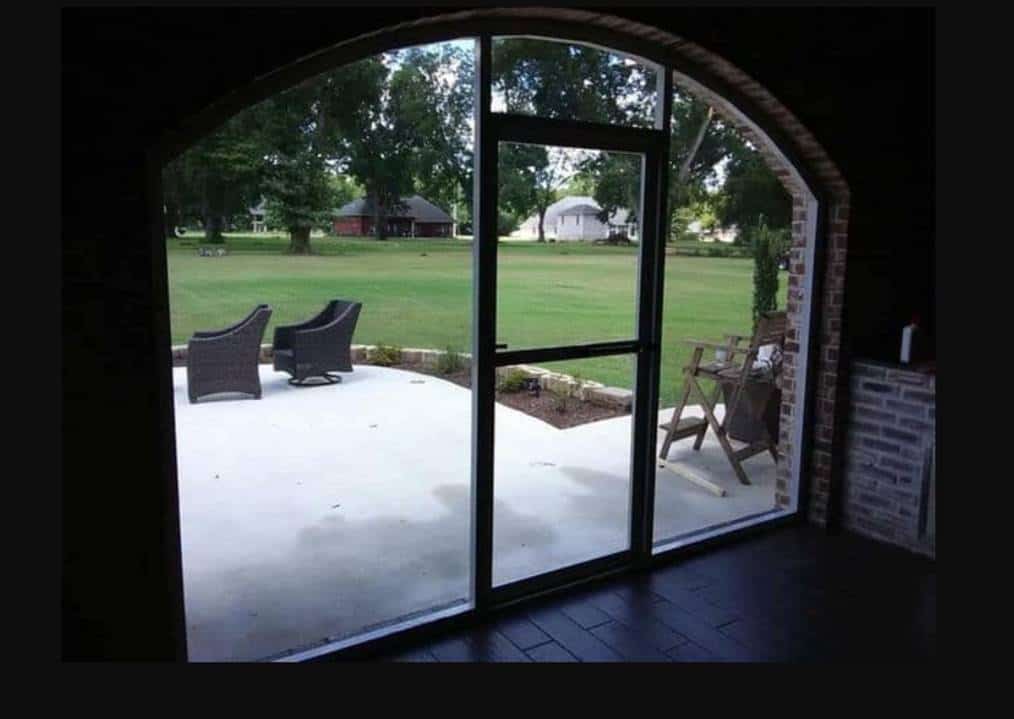 Glass room panels opening to a lawn